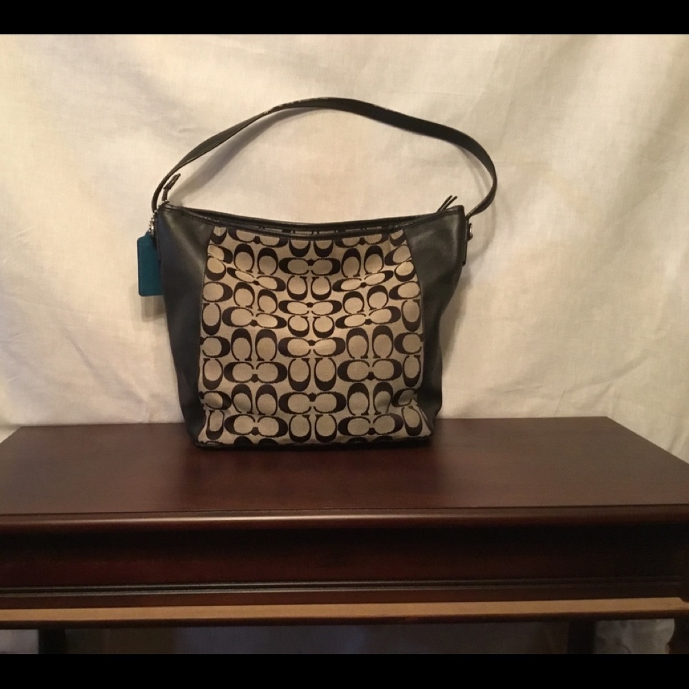 Medium size black and gray Coach shoulder bag.